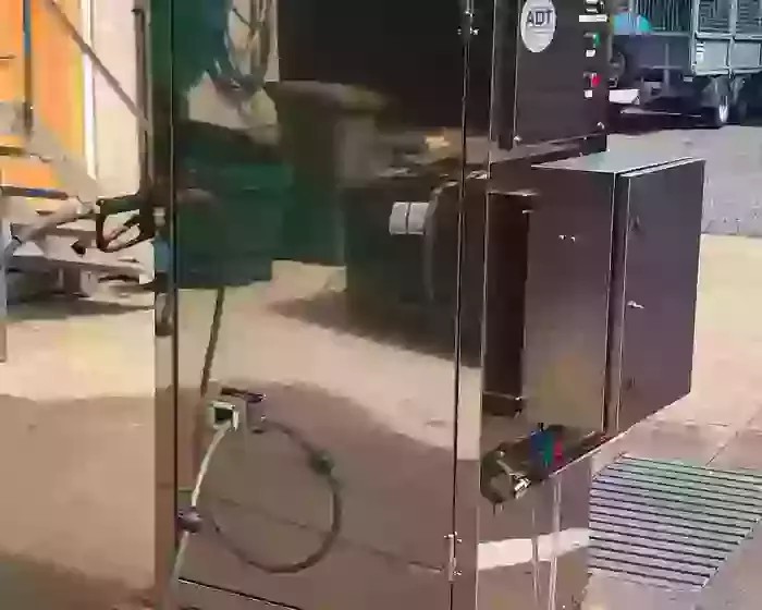 Completed stainless steel wheel wash system built into a DTE cabinet, designed for outdoor installation at a hatchery. This bespoke unit houses a CAT pump, multi-stage detergent system, internal hose reel, and water inlet tank to provide a controlled and 